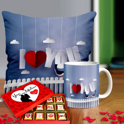 Valentine gift set featuring premium chocolates, a romantic printed mug, and a soft cushion – perfect for expressing love to your partner.