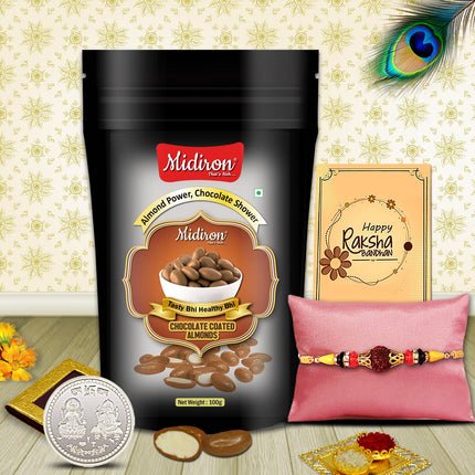 Elegant Raksha Bandhan gift set featuring designer Rakhi, silver coin, chocolate almonds pouch, traditional powders, and a warm greeting card.