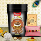 Elegant Raksha Bandhan gift set featuring designer Rakhi, silver coin, chocolate almonds pouch, traditional powders, and a warm greeting card.