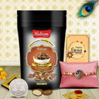 Rakhi gift combo with luxurious treats — chocolate almonds, roli-chawal, silver coin, and heartfelt greeting card for brother.