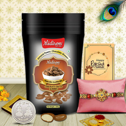 Raksha Bandhan combo with rich chocolate almonds, designer Rakhi, silver coin, and traditional greeting card in an elegant display.