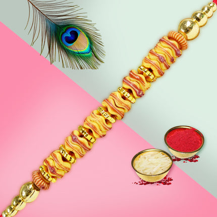 Contemporary Rakhi with a wheel-inspired design, combining tradition with modern aesthetics.