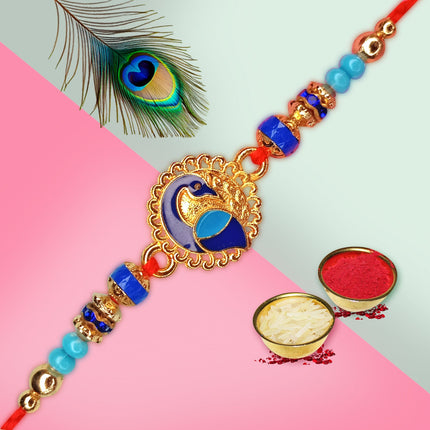 Decorative rakhi with peacock feather, haldi-kumkum 