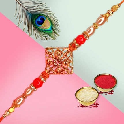 Decorative Rakhi with red beads and gold accents 