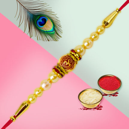 Sacred Rakhi adorned with an “Om” charm and spiritual elements, celebrating divine connection on Raksha Bandhan