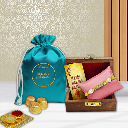Raksha Bandhan gift set featuring designer Rakhi in a wooden box, 90g chocolate pouch, greeting card, and roli-chawal, curated to delight your brother.