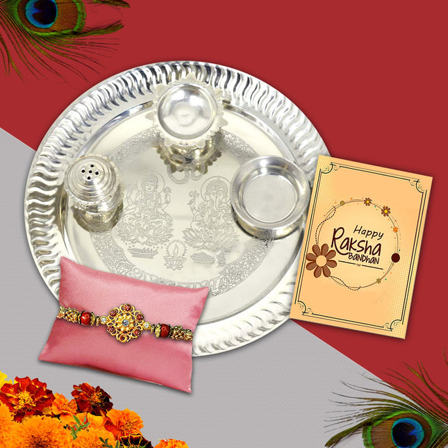 Refined gift basket including intricate Rakhi, silver thali, ritual powders, and festive card for brotherly devotion.