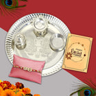 Rakhi gift box capturing the spirit of tradition with pooja plate, roli-chawal, designer Rakhi, and greeting card.