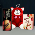 Red teddy bear with a pink bow, box of Dark Fantasy Choco Fills, and a card with floral design 