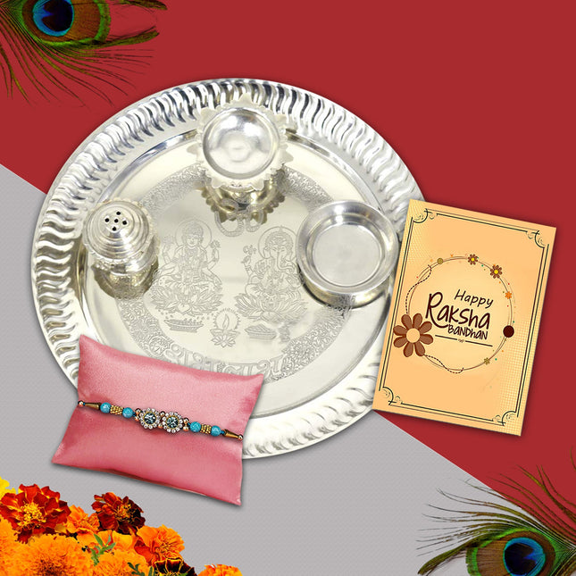 Raksha Bandhan essentials with symbolic Rakhi, ornate silver plate, sacred powders, and loving card.