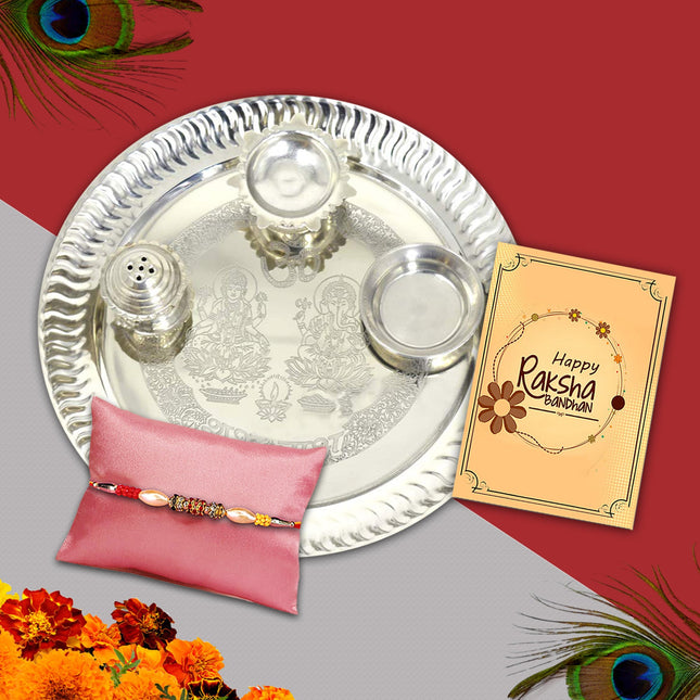 silver plated thali with traditional rakhi and a greeting card 